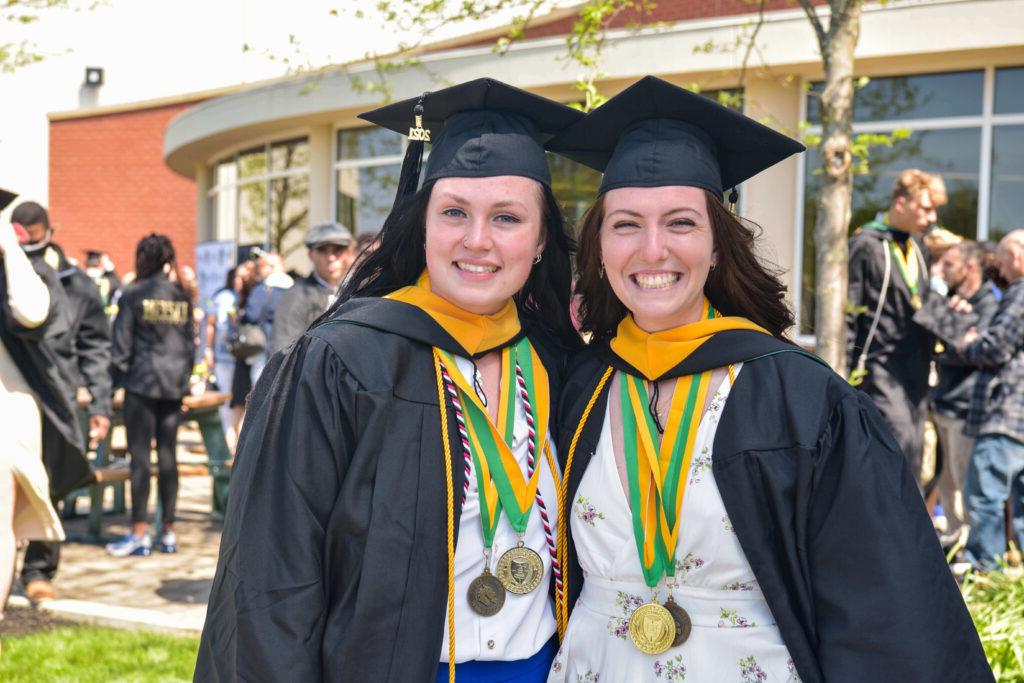 graduates outside with honors